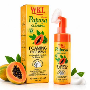 Yellow WKL Papaya Cleaning Foaming Face Wash box and matching orange pump bottle with papaya image and green leaves, plus fresh papayas nearby.