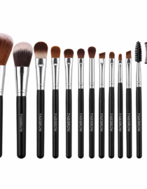 Set of makeup brushes with black handles and silver ferrules lined up from large powder brush to small detail brushes.