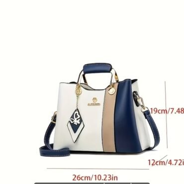 Color block handbag with navy white and beige panels gold hardware and a detachable strap measures 26×19×12 cm 1023×748×472 in