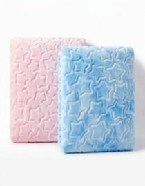 Two plush star patterned blankets pink and blue folded and standing on a white surface