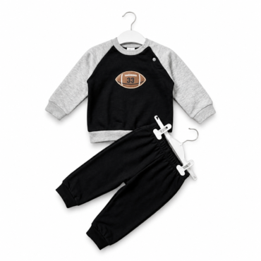 Youth size black sweatshirt with gray sleeves and a football patch on the chest, paired with black joggers on a hanger.