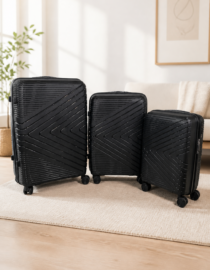Three black hard shell suitcases of different sizes with diagonal line patterns and wheels standing upright on a white backdrop travel luggage set