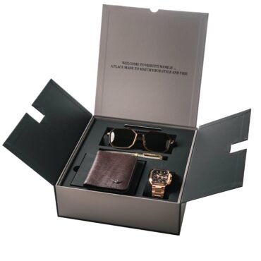 Open black presentation box showing a brown leather wallet, a rose-gold watch, and a matching bracelet-style watch with sunglasses nearby.