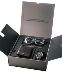 Open black presentation box displaying a set of items eyeglasses wallet and a wristwatch inside compartments