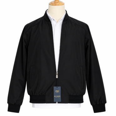 Black bomber jacket on a mannequin with a white dress shirt underneath; front zipper, two side pockets, and ribbed cuffs and hem, with a product tag hanging from the zipper.
