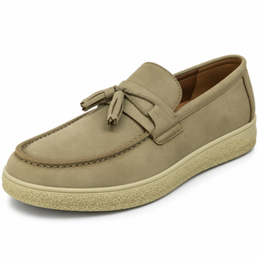 Beige suede loafer with tassel detail and textured beige sole, side view on white background.