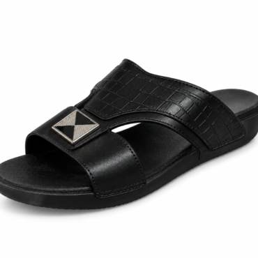 Black slide sandal with a textured croc-pattern strap and a silver square geometric ornament on the top strap