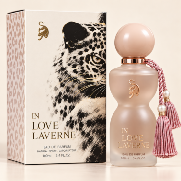 Frosted pink perfume bottle with gold logo beside a leopard-patterned box labeled In Love Laverne, with a pink tassel.