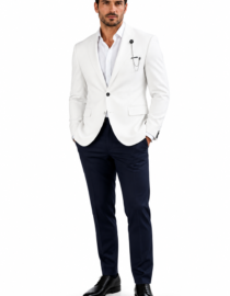 Man in a white blazer and navy trousers standing with hands in pockets black dress shoes confident pose