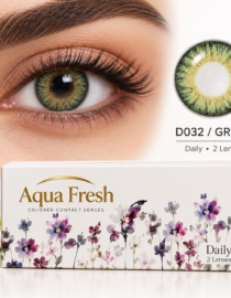 Close up of a green eyed person wearing Aqua Fresh Daily contact lenses with a floral patterned box in the foreground