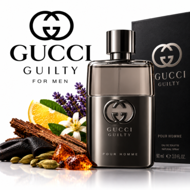 Gucci Guilty Pour Homme fragrance bottle with its black box, set among lavender, orange slice, and spices on a reflective surface.