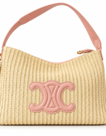 Beige woven straw shoulder bag with pink leather trim and a large pink emblem on the front
