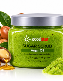 Green jar of Globalstar Sugar Scrub with Argan Oil surrounded by green granules and nuts bottle highlights moisturizing product